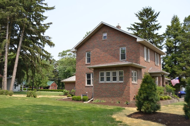 1211 S Sandusky Ave, Bucyrus, OH 44820 - view of side of home with brick siding, a chimney, and a yard