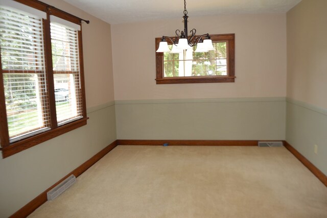 1211 S Sandusky Ave, Bucyrus, OH 44820 - unfurnished room with healthy amount of natural light, a chandelier, and light carpet