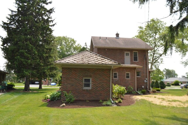 1211 S Sandusky Ave, Bucyrus, OH 44820 - back of property with a yard, brick siding, and a chimney