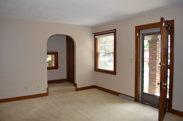 1211 S Sandusky Ave, Bucyrus, OH 44820 - unfurnished room with arched walkways, light colored carpet, and baseboards