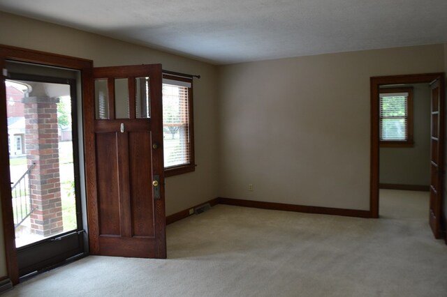1211 S Sandusky Ave, Bucyrus, OH 44820 - entrance foyer featuring light carpet and baseboards