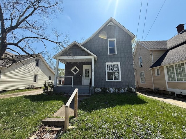bungalow-style home with a front lawn and covered porch