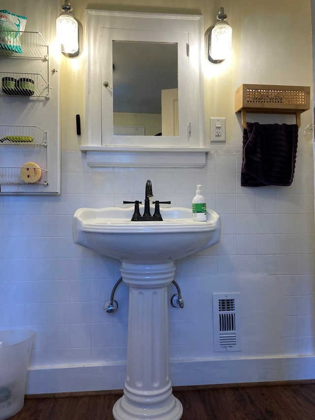 bathroom featuring tasteful backsplash, tile walls, and hardwood / wood-style flooring