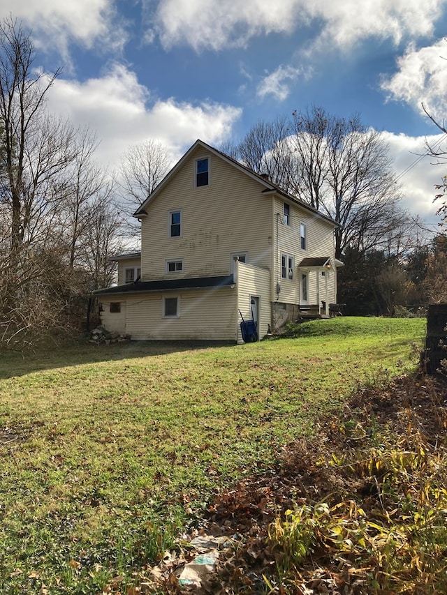 view of home's exterior featuring a yard