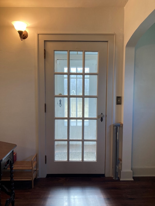 doorway to outside featuring dark wood-type flooring