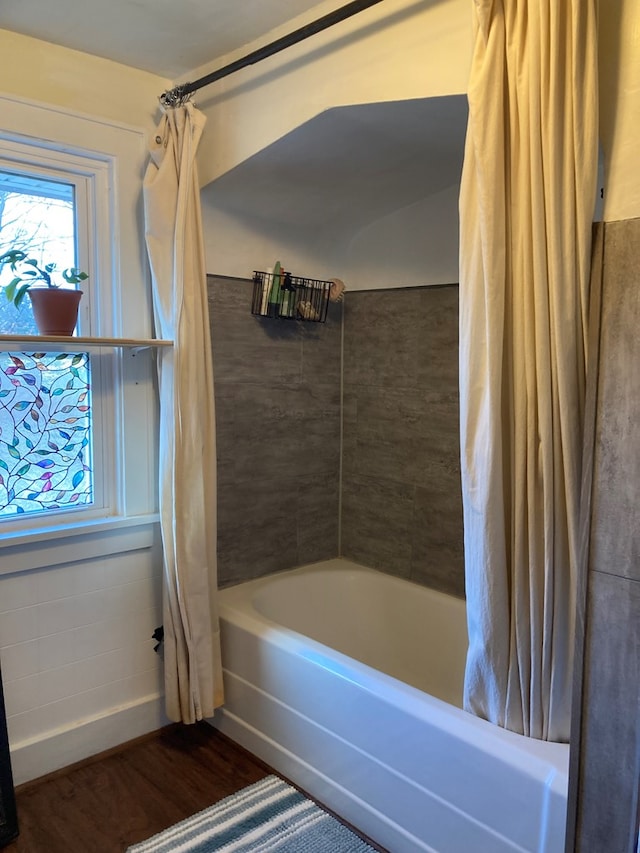 bathroom featuring hardwood / wood-style floors and shower / tub combo