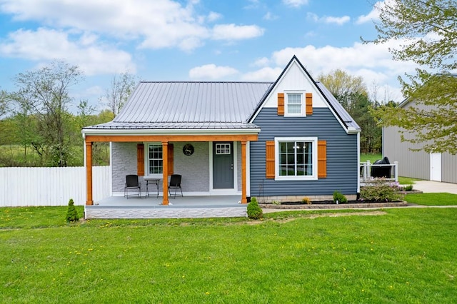 bungalow-style house with fence, a porch, metal roof, and a front yard