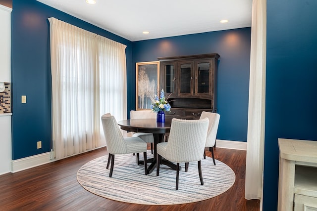 dining space with dark hardwood / wood-style flooring