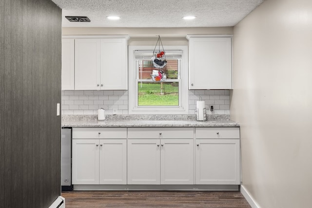 426 Charvid Ave, Mansfield, OH 44905 - kitchen featuring dark wood-style floors, white cabinetry, tasteful backsplash, a textured ceiling, and recessed lighting