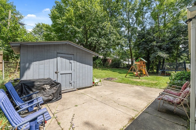 426 Charvid Ave, Mansfield, OH 44905 - view of patio featuring a trampoline, a playground, and a storage unit