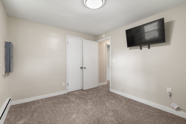 426 Charvid Ave, Mansfield, OH 44905 - unfurnished bedroom featuring a baseboard heating unit, carpet, and electric panel