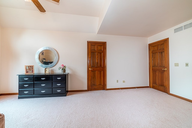 unfurnished bedroom with ceiling fan and carpet