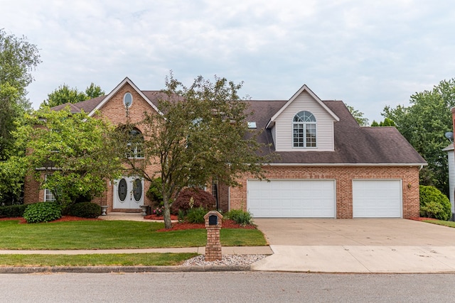 view of front of house featuring a garage and a front lawn