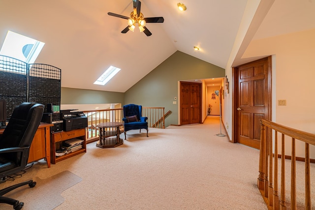 carpeted home office featuring ceiling fan and lofted ceiling with skylight