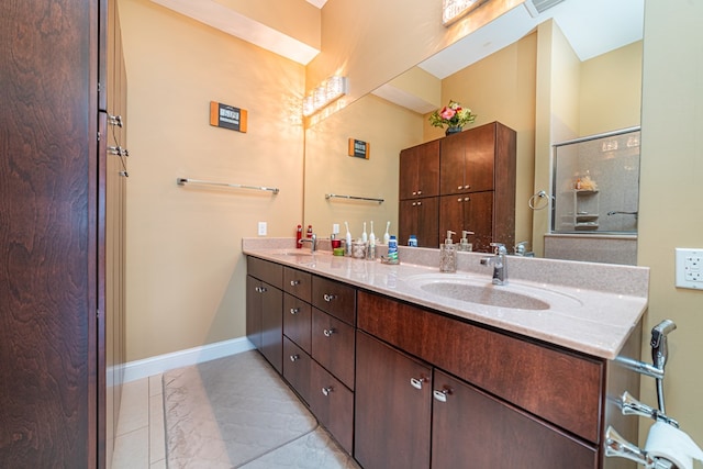 bathroom with vanity and a shower with door