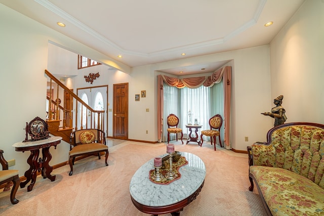 sitting room featuring a tray ceiling and light colored carpet