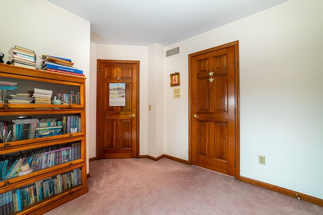 foyer featuring light carpet