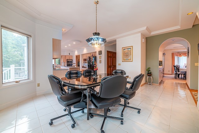 tiled dining area featuring plenty of natural light, a chandelier, and ornamental molding