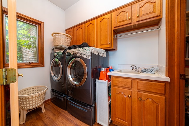 washroom featuring cabinets, washer and clothes dryer, hardwood / wood-style floors, and sink