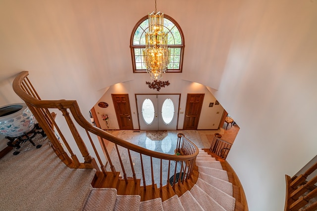 foyer featuring a high ceiling and an inviting chandelier