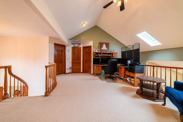 office featuring vaulted ceiling with skylight, ceiling fan, and carpet floors