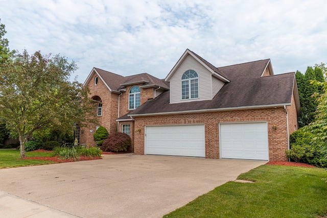 view of front of property featuring a front lawn and a garage