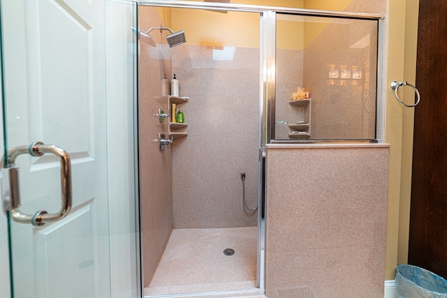 bathroom with a shower with door