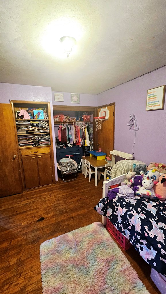 bedroom with dark wood-type flooring and a textured ceiling