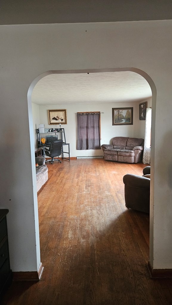 corridor with hardwood / wood-style floors