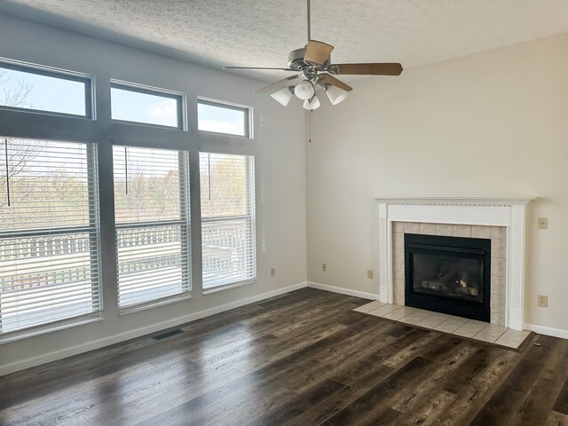 105 Purple Finch Loop, Pataskala, OH 43062 - unfurnished living room with dark wood-type flooring, a fireplace, ceiling fan, and visible vents