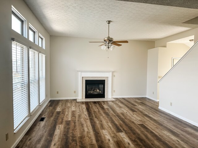 105 Purple Finch Loop, Pataskala, OH 43062 - unfurnished living room with dark wood-type flooring, a fireplace, ceiling fan, and visible vents