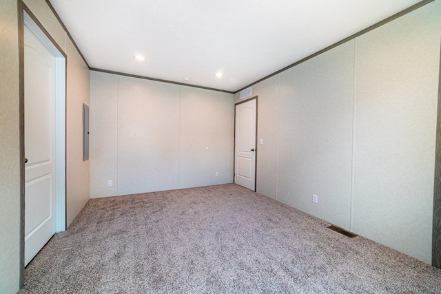 unfurnished room featuring electric panel, crown molding, and carpet floors