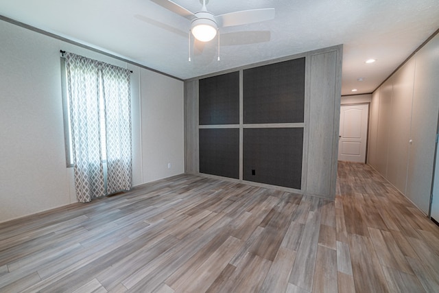 empty room featuring ceiling fan and light wood-type flooring