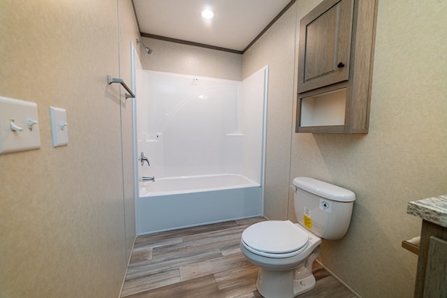 full bathroom featuring hardwood / wood-style floors, vanity, bathing tub / shower combination, and ornamental molding