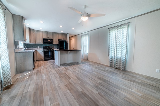 kitchen with sink, light hardwood / wood-style floors, ceiling fan, and black appliances