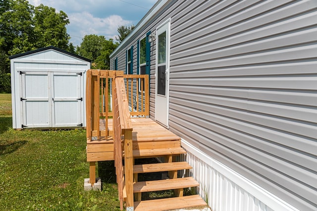 deck with a yard and a storage shed