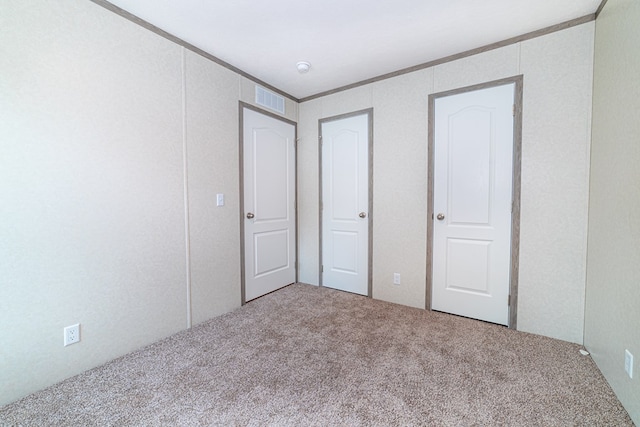 unfurnished bedroom with carpet flooring and crown molding