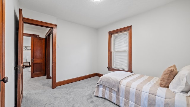 bedroom with light carpet and a textured ceiling