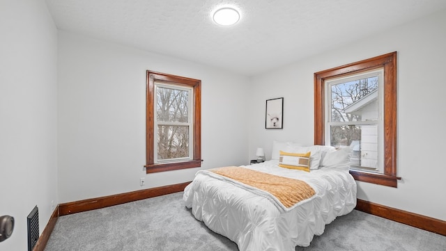 carpeted bedroom featuring a textured ceiling