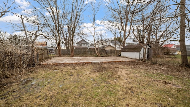 view of yard featuring a shed and a patio area