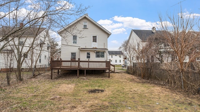 back of property featuring a lawn and a deck