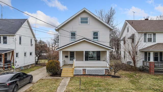 front of property featuring a front lawn and covered porch