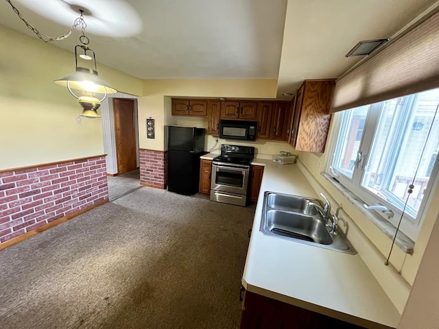 kitchen with brick wall, sink, light colored carpet, and black appliances