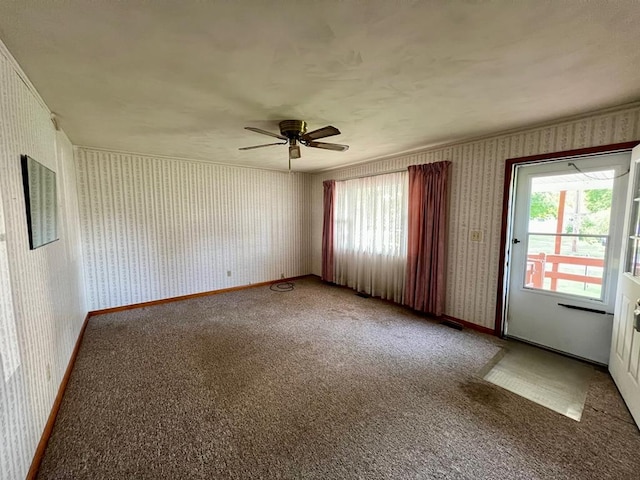 carpeted empty room featuring ceiling fan and a healthy amount of sunlight