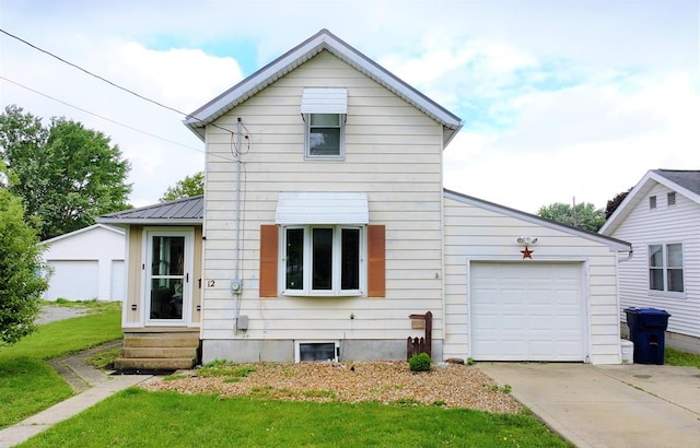 12 W Park Dr, Shelby, OH 44875 - view of front facade with entry steps, driveway, a garage, a front lawn, and metal roof