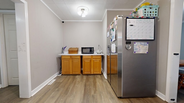 12 W Park Dr, Shelby, OH 44875 - kitchen featuring crown molding, freestanding refrigerator, light wood-style floors, light countertops, and baseboards