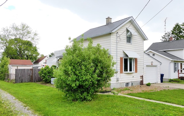 12 W Park Dr, Shelby, OH 44875 - view of property exterior featuring driveway, metal roof, an attached garage, and a chimney