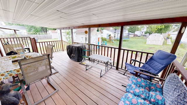 12 W Park Dr, Shelby, OH 44875 - wooden deck with area for grilling, a playground, and outdoor dining area