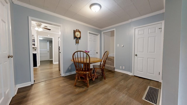 12 W Park Dr, Shelby, OH 44875 - dining space with dark wood-style floors, ornamental molding, ceiling fan, and baseboards