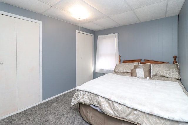 carpeted bedroom featuring a paneled ceiling